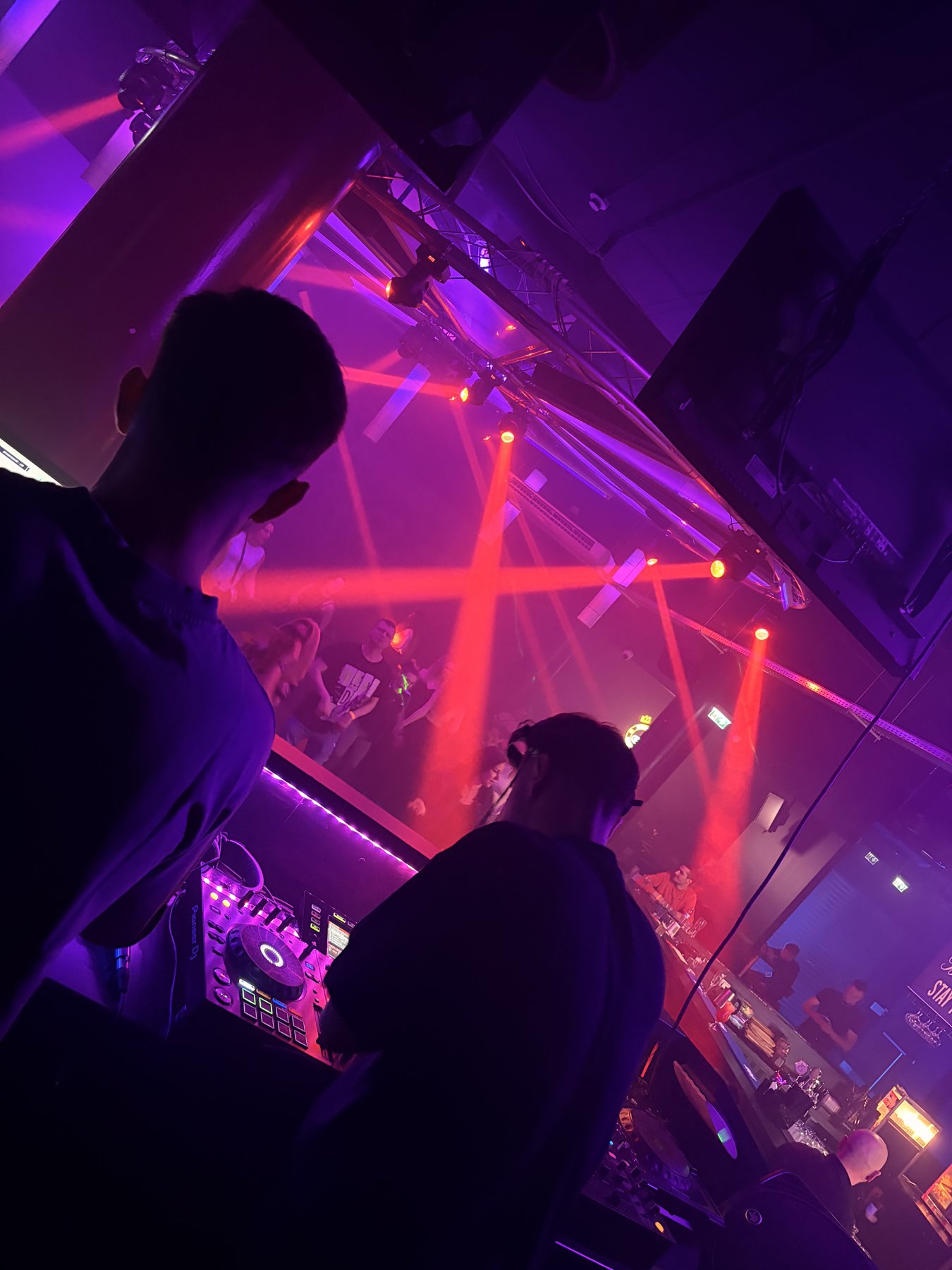 2SHER x MAJLOS behind the decks, red lights over a full floor